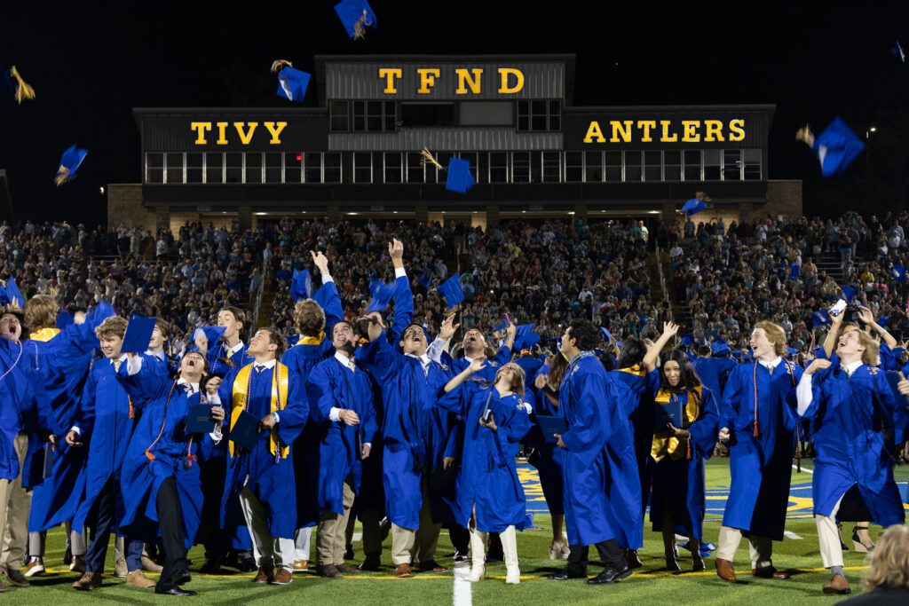 Graduates toss their caps in the air at the conclusion of the graduation ceremony at Antler Stadium.